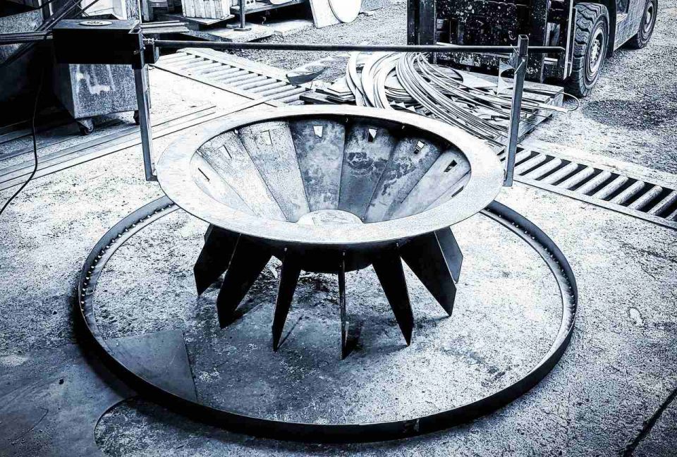 Fire pit set up with large base ring and roaster on top, perfect for Australian backyard roasts